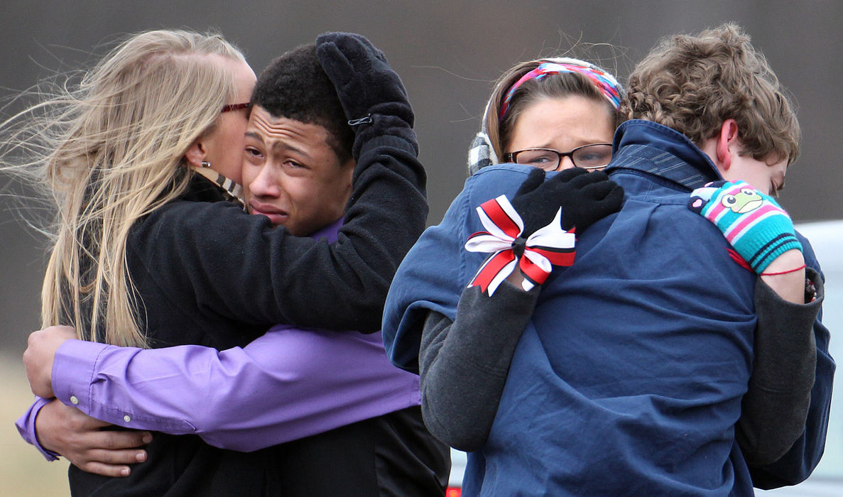 First place, Team Picture Story - John Kuntz / The Plain DealerFriends and classmates of Chardon High School student Daniel Parmertor grieve after saying goodbye to Daniel for the last time after leaving his gravesite.  (John Kuntz / The Plain Dealer)