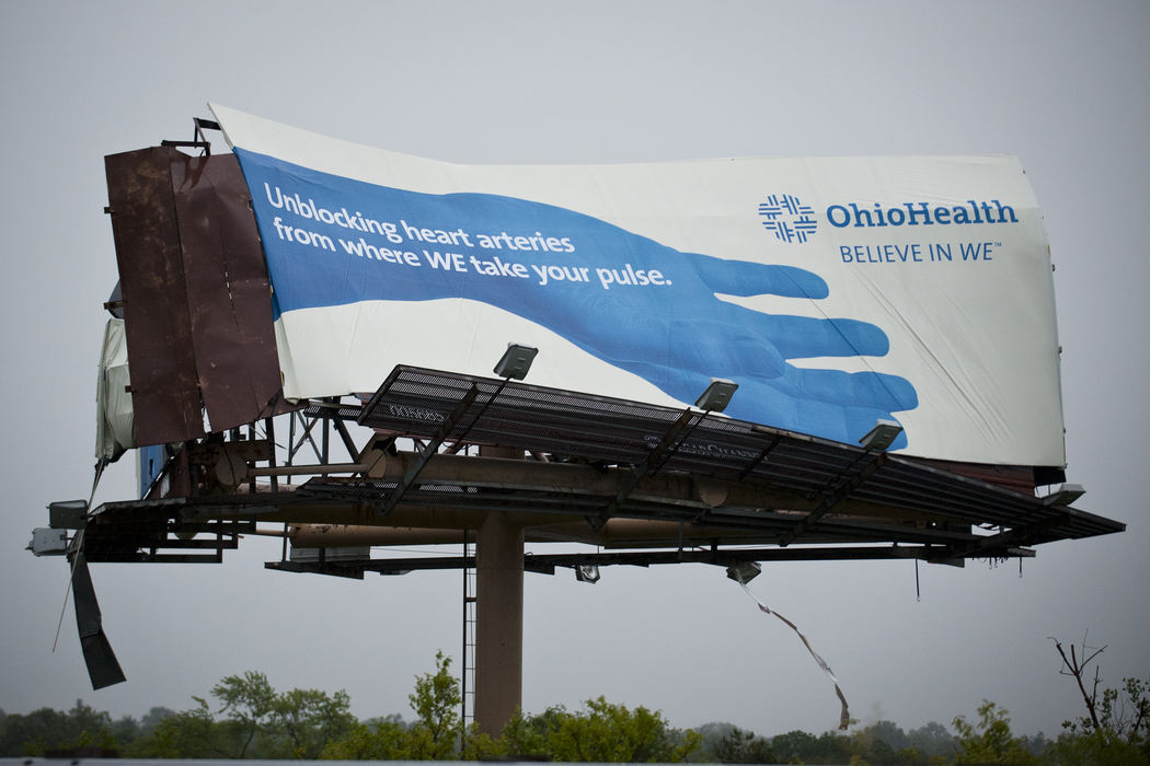 Second place, Team Picture Story - Eamon Queeney / The Columbus DispatchAn OhioHealth billboard was mangled from Friday afternoon's severe storm, June 29, 2012. A storm front with hurricane-force winds blew through central Ohio Friday leaving thousands without power and damaging other property.