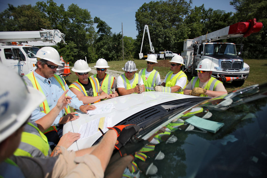 Second place, Team Picture Story - Courtney Hergesheimer / The Columbus DispatchCrew from DET Power from Detroit work with AEP to get power restored to the Pleasant Acres trailer park in Darby Dale area, who lost it in yesterday's storm, Monday, July 2, 2012. 