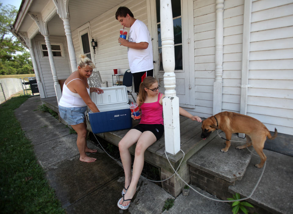 Second place, Team Picture Story - Courtney Hergesheimer / The Columbus DispatchThe Joyner  family from left, Marcia, her son Andrew, 14, and daughter Emma, 11, try to keep cool on their porch, on their sixth day without power, in Newark, OH, Thursday, July 6, 2012. 