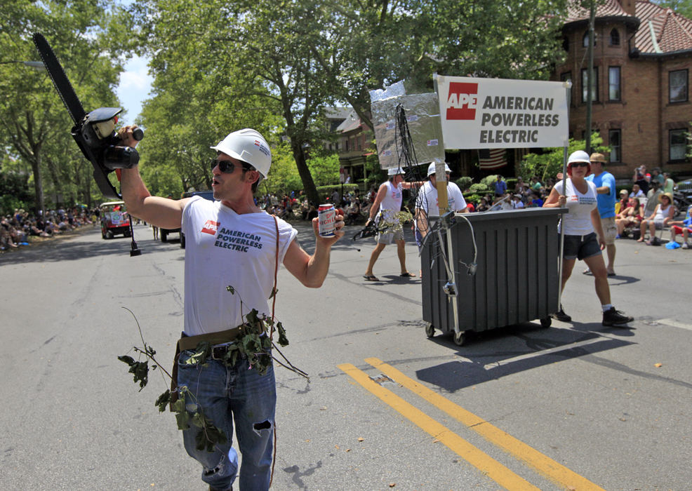 Second place, Team Picture Story - Brooke LaValley / The Columbus DispatchPaulie Anthony holds up a chainsaw while impersonating an American Electric Power worker (Renamed as "APE") during the irreverent Doo Dah Parade in Columbus, Ohio on July 4, 2012. 