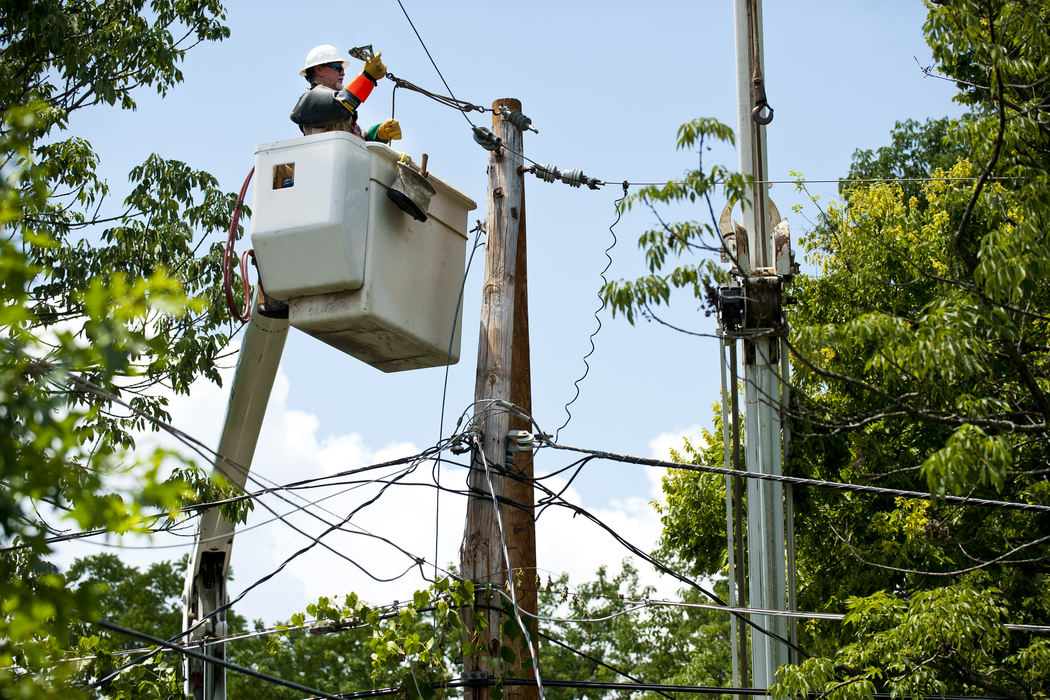 Second place, Team Picture Story - Eamon Queeney / The Columbus DispatchLineman with Hooper Corporation, Rick Super, of Dayton, takes all the old connections off a snapped telephone pole to attach them to a brand new pole behind homes on Woodbine Place in Clintonville, Wednesday afternoon, July 4, 2012. Many Clintonville residents were finally getting power Wednesday after a five day period with no air conditioning and scorching temperatures. 