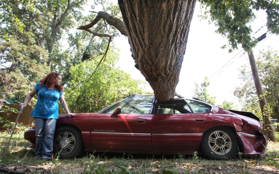 Second place, Team Picture Story - Eric Albrecht / The Columbus DispatchKelly Boyd leans against her boyfriend's car at her Clintonville home. Her landlord has yet to remove the tree from the yard more than a month after the Derecho. 