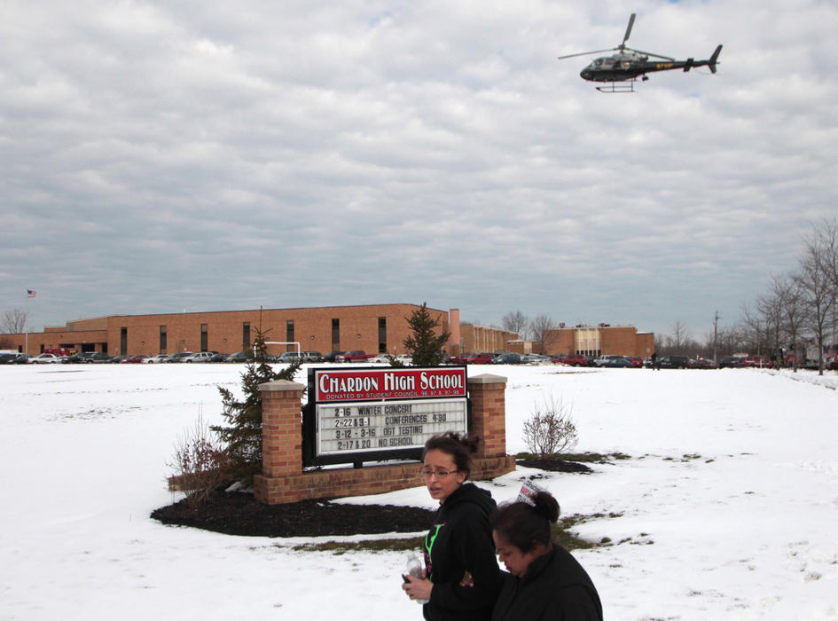 First place, Team Picture Story - Thomas Ondrey / The Plain DealerA State Highway Patrol helicopter prepares to land in front of Chardon High School as students and parents exit the campus.  (Thomas Ondrey/The Plain Dealer)