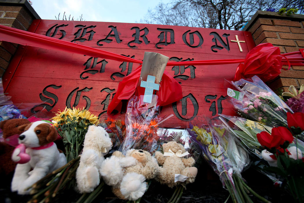 First place, Team Picture Story - Lisa DeJong / The Plain DealerA memorial rose from tragedy at the sign for Chardon High School as the community began to cope its loss. (Lisa DeJong/ THe Plain Dealer)