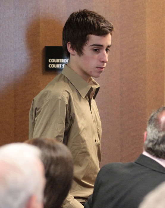 First place, Team Picture Story - Thomas Ondrey  / The Plain DealerT.J. Lane, the teen-ager charged with killing three of his Chardon High School classmates and injuring two, enters Geauga County Juvenile Court for a hearing on March 6. His maternal grandparents are seated in foreground with backs to camera. (Thomas Ondrey/The Plain Dealer)