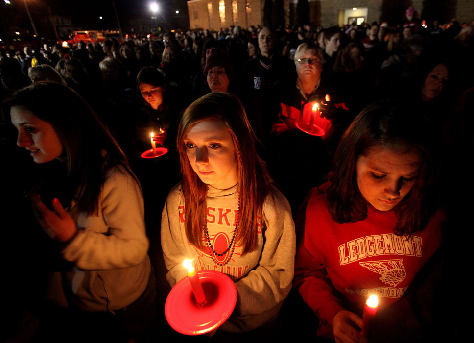First place, Team Picture Story - Lisa DeJong / The Plain DealerSarah Fatheringham, left, and her friend Moriah Thompson, right, both from Ledgemont High School in Thompson Township in Geauga County, joined several thousand mourners at a vigil outside St. Mary Catholic Church across the street from Chardon High School. The service included prayers, singing and reassuring words from Gov. John Kasich.  (Lisa DeJong/The Plain Dealer)