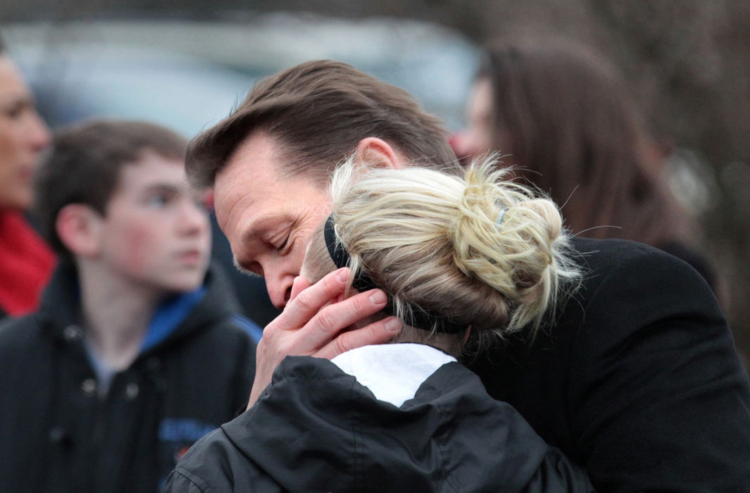 First place, Team Picture Story - Thomas Ondrey / The Plain DealerChardon Schools Superintendent Joe Bergant embraces a returning student as the high school reopened.   Bergant stood near the doors and hugged nearly every student who walked by.  "Talk to your children today. Hug them," he told parents.  (Thomas Ondrey/The Plain Dealer)