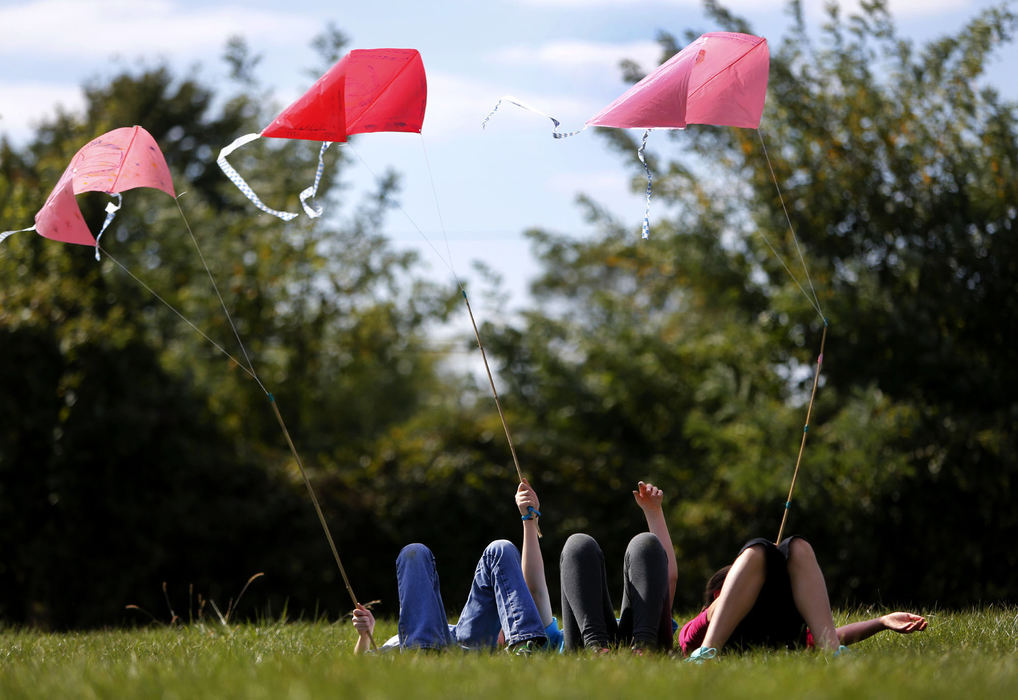 Award of Excellence, Feature - Fred Squillante / The Columbus DispatchColumbus Jewish Day School sixth-graders (from left) Maya Rothchild, Tal Mars, and Arrie Zimmerman relax as they fly kites to celebrate the holiday of Sukkot- also known as the Feast of Booths. They were remembering Janusz Korczak, who headed an orphanage in Poland during World War II until he and his charges were killed in Treblinka. Korczak gave his children kites to distract them, saying, "A kite is a gift of the wind to a child."