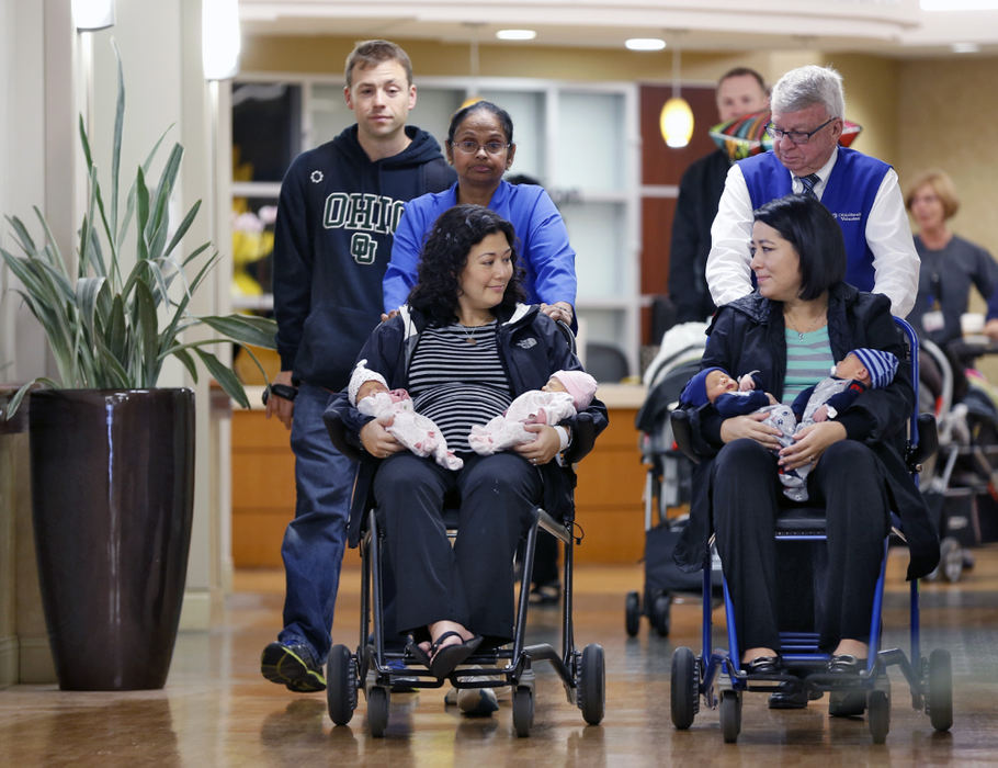 First Place, Feature Picture Story - Chris Russell / The Columbus Dispatch Holding the newborns, Annie and Chrissy  leave Riverside Hospital together.