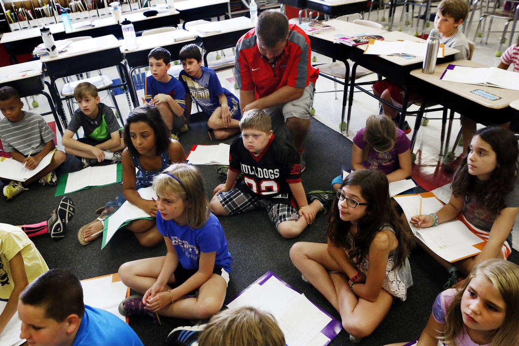 Second Place, Feature Picture Story - Eric Albrecht / The Columbus DispatchMurphy Vetter 11 listens to a story along with other members of his 4th grade class. Matt Ashworth his aid and his youth football coach is a constant presence in the classroom. 