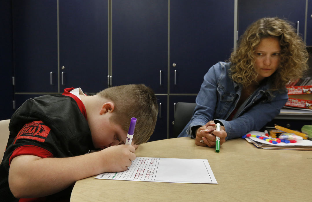 Second Place, Feature Picture Story - Eric Albrecht / The Columbus DispatchMurphy Vetter 11 works on schoolwork with his occupational specialist Adrianne Pence.