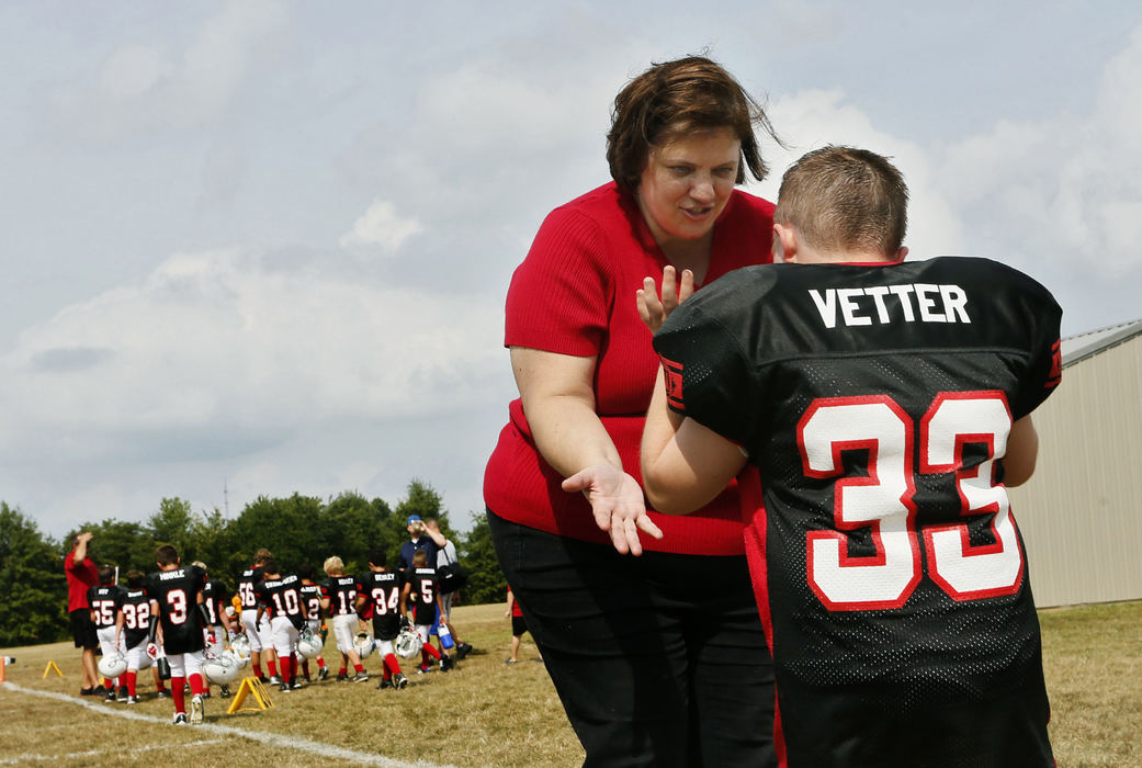 Second Place, Feature Picture Story - Eric Albrecht / The Columbus DispatchMurphy Vetter 11 is greeted by his mom Tina Vetters at the end of their game against the Mountaineers .