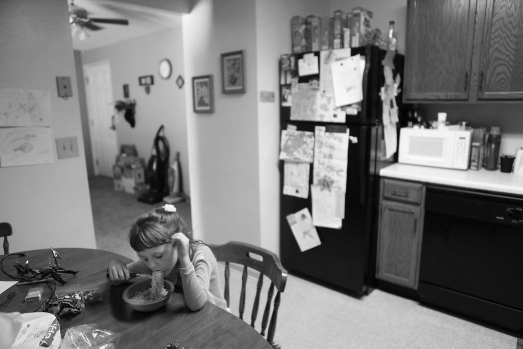 Third Place, Feature Picture Story - Carrie Cochran / Cincinnati EnquirerHope eats lunch by herself as her mother sleeps, and her stepfather watches television. Hope has learned to become very independent.