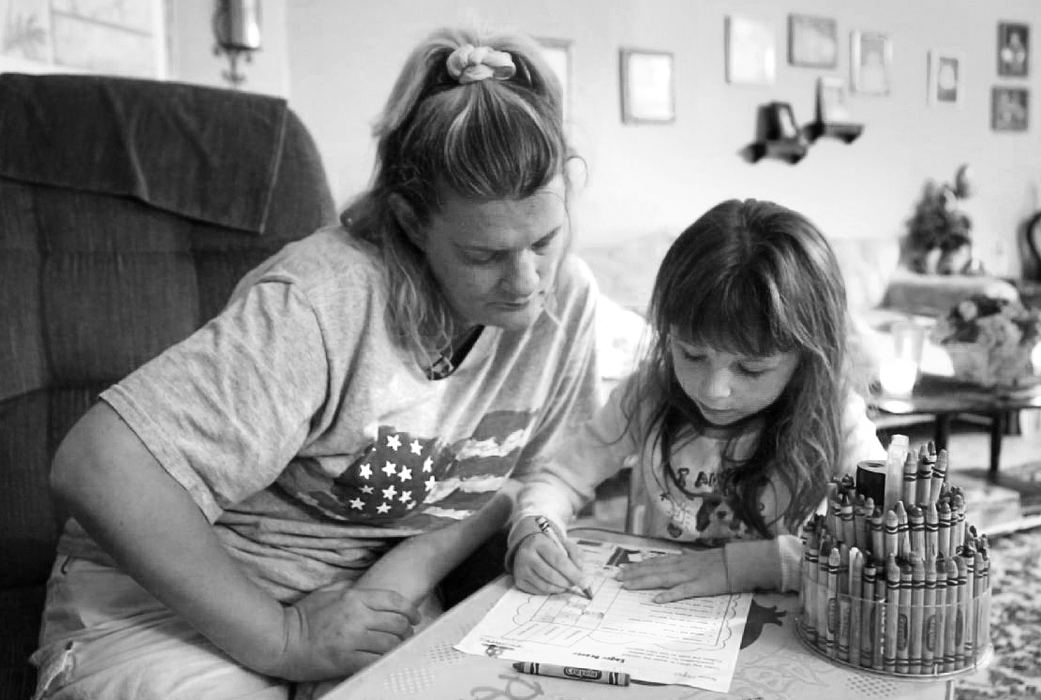 Third Place, Feature Picture Story - Carrie Cochran / Cincinnati EnquirerTricia Espich helps her daughter, Hope LaRoche, 7, with her homework. Tricia usually does the evening routine with Hope.
