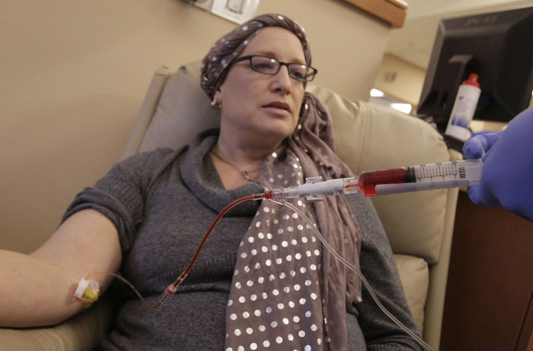 Award of Excellence, Feature Picture Story - Karen Schiely / Akron Beacon JournalMichelle Lang-Schock watches as oncology nurse Veronica Shea administers one of her chemotherapy drugs at the Summa Barberton Parkview Center. 