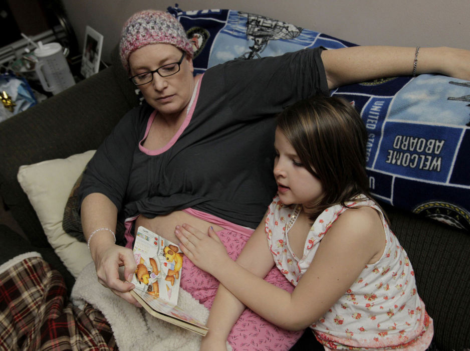 Award of Excellence, Feature Picture Story - Karen Schiely / Akron Beacon JournalBella Wertman, 6, reads a bedtime story to her unborn sister as her mother Michelle Lang-Schock holds the book at their apartment in Wadsworth. 