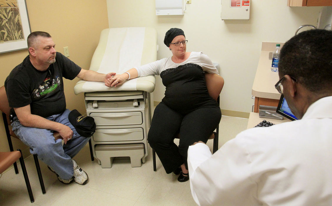 Award of Excellence, Feature Picture Story - Karen Schiely / Akron Beacon JournalHarry Schock holds the hand of his wife Michelle as radiation oncologist Dr. William Demas recommends radiation therapy one month after the birth of their child. Michelle was hoping to avoid radiation. 