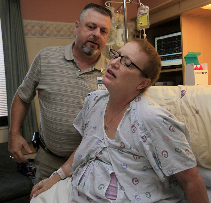 Award of Excellence, Feature Picture Story - Karen Schiely / Akron Beacon JournalHarry Schock rubs the back of his wife Michelle as he attempts to comfort her through a painful contraction before the birth of their child at the Akron General Medical Center.