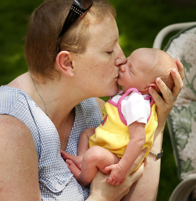 Award of Excellence, Feature Picture Story - Karen Schiely / Akron Beacon JournalMichelle Lang-Schock kisses her three-day-old daughter Charli during a delayed Mother's Day gathering at her family's apartment.