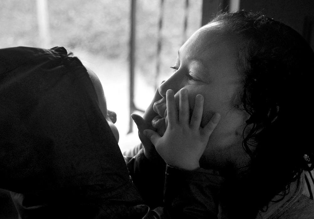 Award of Excellence, Feature Picture Story - Kristin Bauer / The (Elyria) Chronicle-TelegramTabitha and her daughter Aurora, 3, sit in the doorway of their new home for the first time as Aurora kisses her mother within minutes of entering the home. This is both Aurora and her mother's first home.