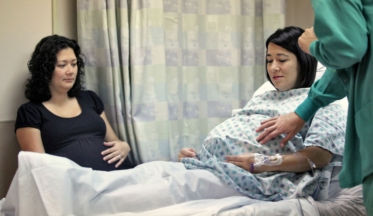 First Place, Feature Picture Story - Chris Russell / The Columbus Dispatch Annie Johnston watches as her sister Chrissy Knott is prepared for a cesarian section on October 24 at Riverside Hospital's Women's Health Center.   