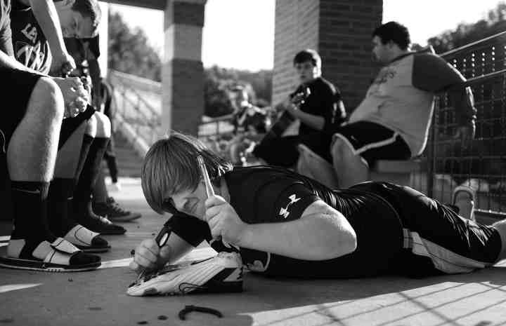 First Place, Larry Fullerton Photojournalism Scholarship - Jenna Watson / Kent State UniversityIn only one night, a glimpse into high school football demonstrates the meaning of Friday Night lights to the small town of Hyden, Kentucky. A player uses a pair of tools on his cleats with determination before the Leslie County High School game against Betsy Layne in Hyden, Kentucky. Players spend downtime on the school balcony playing guitars, preparing gear and getting rid of pre-game jitters.