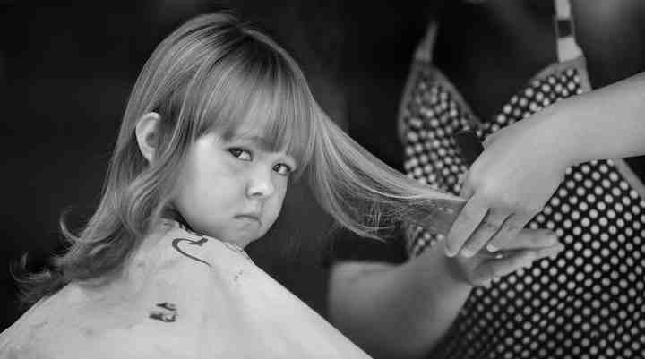 First Place, Larry Fullerton Photojournalism Scholarship - Jenna Watson / Kent State UniversityAbby Joseph, 3, stares through the front window of "Just Around the Corner Hair Salon" in Hyden, Kentucky patiently waiting to see her feminine new hair-do.