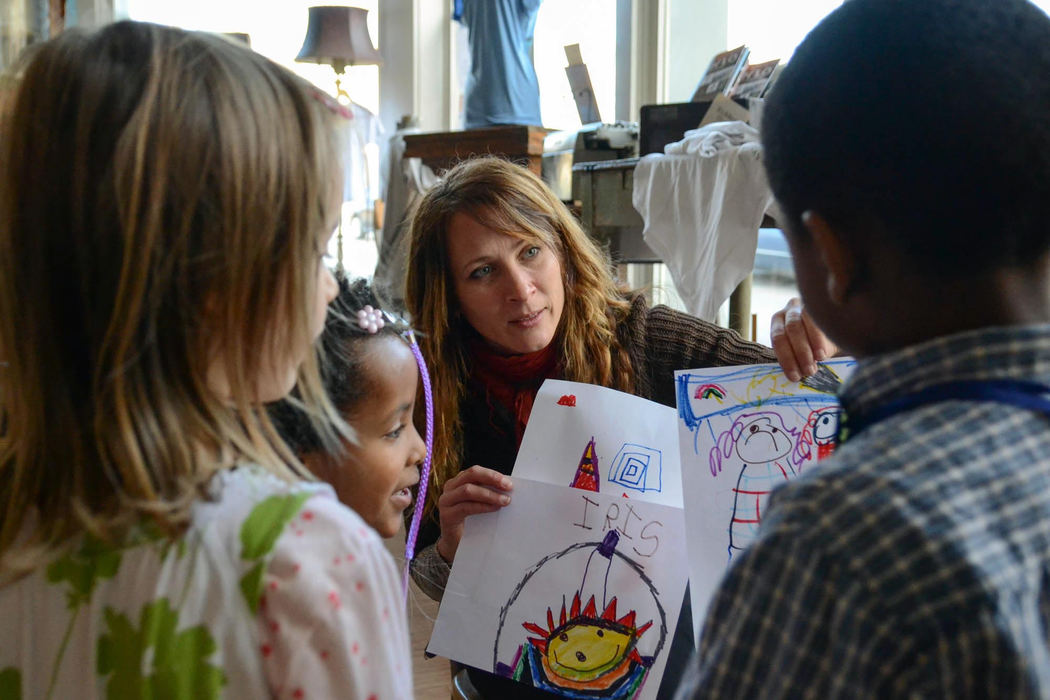 Second Place, Larry Fullerton Photojournalism Scholarship - Madison Schmidt / University of CincinnatiAfter drawing pictures during the Inklings tea party, Dylan joined the group of children to find Libby Hunter, WordPlay executive director. Hunter praised the artwork of each student surrounding her in the room.  "So often are they defined by their failures in school," Hunter said. "The kids light up when they are praised and are shown love."