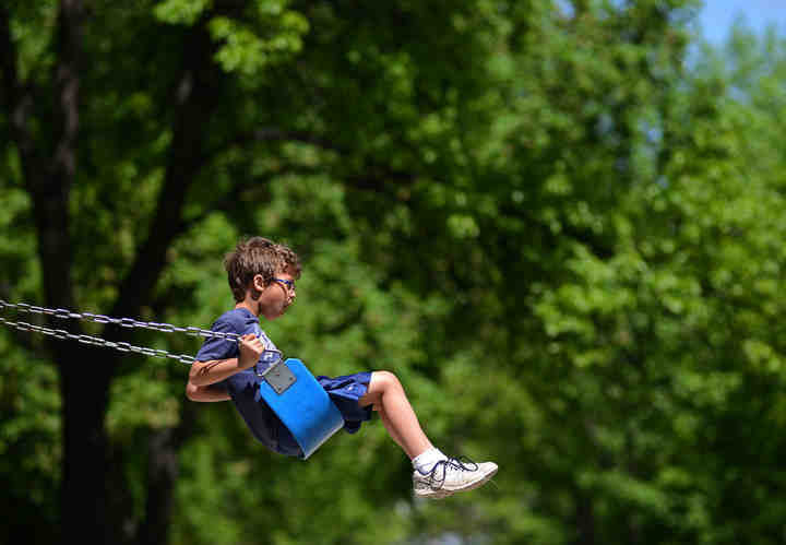 First Place, Larry Fullerton Photojournalism Scholarship - Jenna Watson / Kent State UniversityCaleb Landcaster, 7, swings after taking part in a luncheon at University Park in Grand Forks, N.D., a meal provided by volunteers at St. Joseph's Social Care and Thrift Store. 