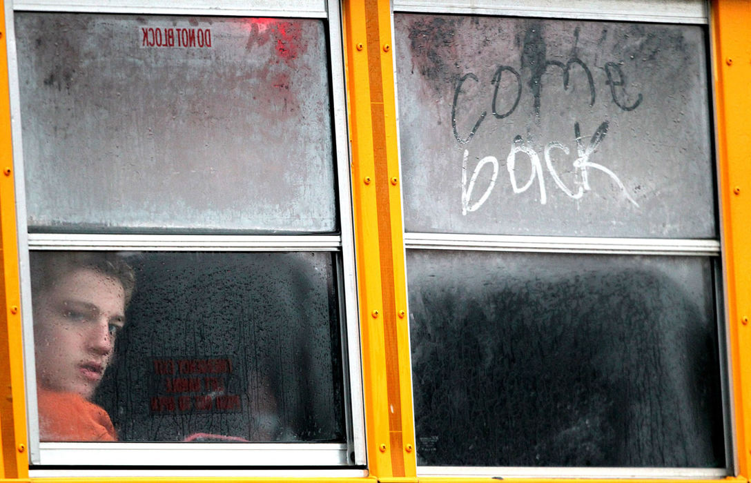 Third Place, General News - Marvin Fong / The Plain DealerSchool buses arrive for the start of another day of classes at Center Middle School in Strongsville, but this bus carried a message to the striking teachers written on the bus window: "Come back." Monday marked two weeks since the beginning of the Strongsville teachers strike. School administrators and teachers left a negotiation session Sunday, led by a federal mediator, with nothing resolved. 