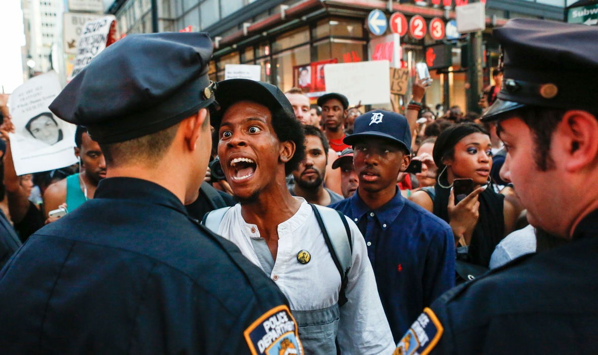 Award of Excellence, General News - Jabin Botsford / Western Kentucky UniversityA day after George Zimmerman was acquitted of all charges in the shooting death of Trayvon Martin, a man argues with New York City police officers at West 34th Street on July 14, 2013. He and thousands of other protesters who questioned the verdict of the trial blocked traffic as they made their way from Union Square to Times Square.