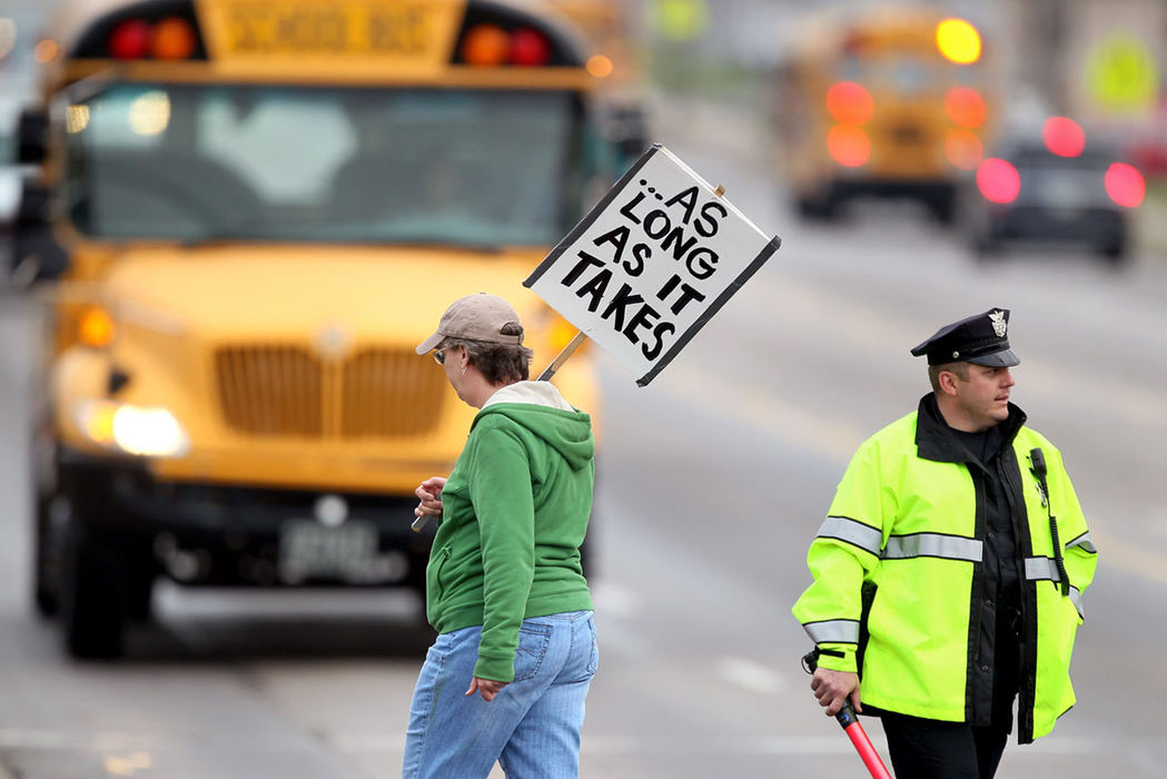 Second Place, News Picture Story - Marvin Fong / The Plain DealerStriking teachers and supporters continue to make their presence known as school buses drive past the Strongsville city schools administration building.   Despite a series of negotiation sessions, there was no deal to end the labor dispute.  