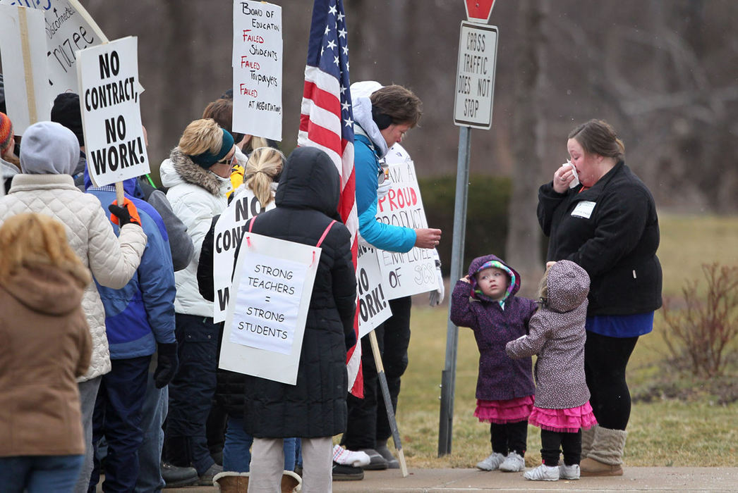 Second Place, News Picture Story - Marvin Fong / The Plain DealerParent Amy Noel wipes her tears as she visits with striking teachers outside Kinsner elementary school in Strongsville.  Noel has a second-grade son, Jacob, 7, who attends the school.  She is accompanied with her twin daughters Makenna, left, and Maisen Lucas, right, 3.