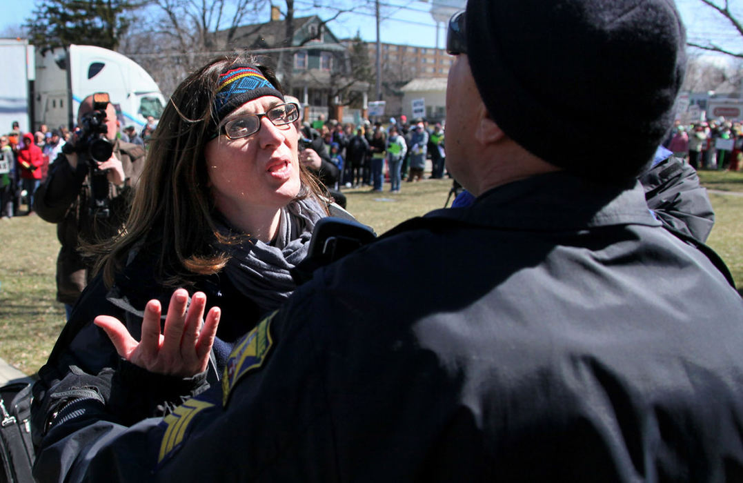 Second Place, News Picture Story - Marvin Fong / The Plain DealerStrongsville Education Association president Tracy Linscott is stopped by a police officer as she walks to the schools administration building.  Linscott was allowed to deliver a message to superintendent John Krupinski, to call for binding interest arbitration for the school strike in its fifth week.