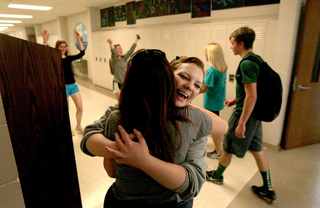 Second Place, News Picture Story - Marvin Fong / The Plain DealerZoe Legato, 17, junior, facing center, embraces her English teacher Heather Keirn-Swanson, at Strongsville high school. The teachers strike was settled over the past weekend and instructors were allowed back into their schools Monday afternoon.