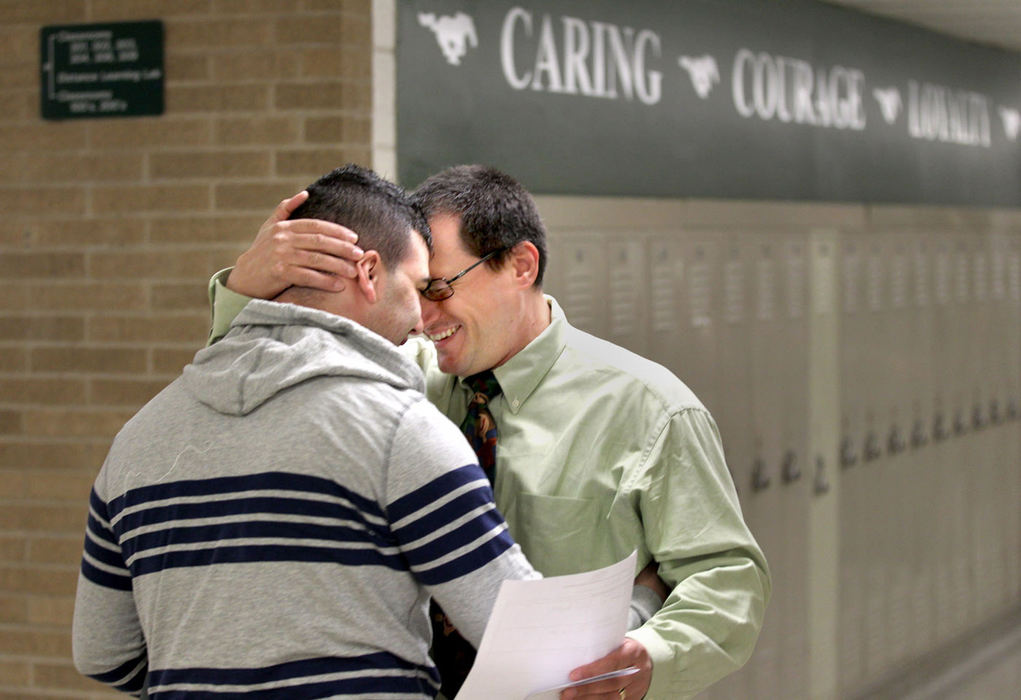 Second Place, News Picture Story - Marvin Fong / The Plain DealerHistory teacher Jess Attilli greets student Aboo Abuhamdeh, a junior, before the start of classes at Strongsville High School in late April.   Hugs and smiles filled the school on the first day that regular teachers were back in class since their strike started in March.  