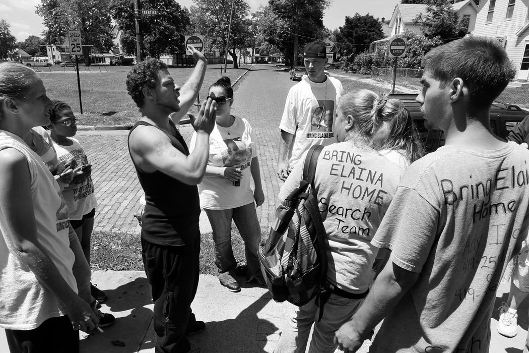 First Place, News Picture Story - Amy E. Voigt / The (Toledo) Blade Leon Oldham, left, gives directions to volunteers, including Terry Steinfurth Jr., center right in baseball cap, the father of missing toddler Elaina Steinfurth, while on a search on June 13, 2013.