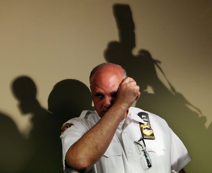 Award of Excellence, News Picture Story - Gus Chan / The Plain DealerDeputy Police Chief Ed Tomba wipes his eyes as he answers questions from the media after the escape of Amanda Berry, Gina DeJesus and Michelle Knight from the home of Ariel Castro.  The three were held prisoner inside the home for more than ten years.