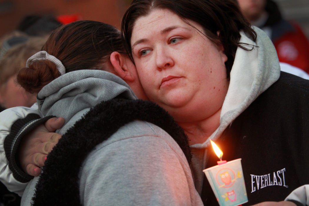 Award of Excellence, News Picture Story - Gus Chan / The Plain DealerTonia Adkins, sister, of Christina Adkins, hugs a childhood friend of her murdered sister. Christina Adkins' body was stuffed in a manhole and her remains went undiscovered for 18 years until her killer, Elias Acevedo, confessed to the crime.