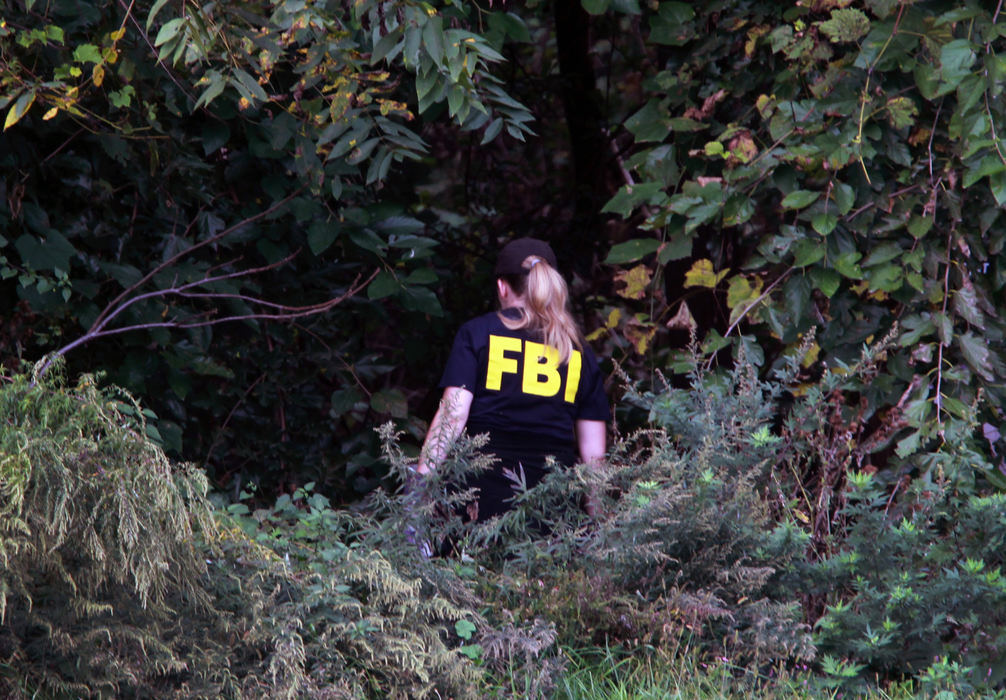 Award of Excellence, News Picture Story - Gus Chan / The Plain DealerA member of the FBI Evidence Response Team scours a field in search of the body of Christina Adkins.  Police were searching the brush near Clark Field after receiving a tip to the missing woman's whereabouts. Adkins has been missing since 1995.