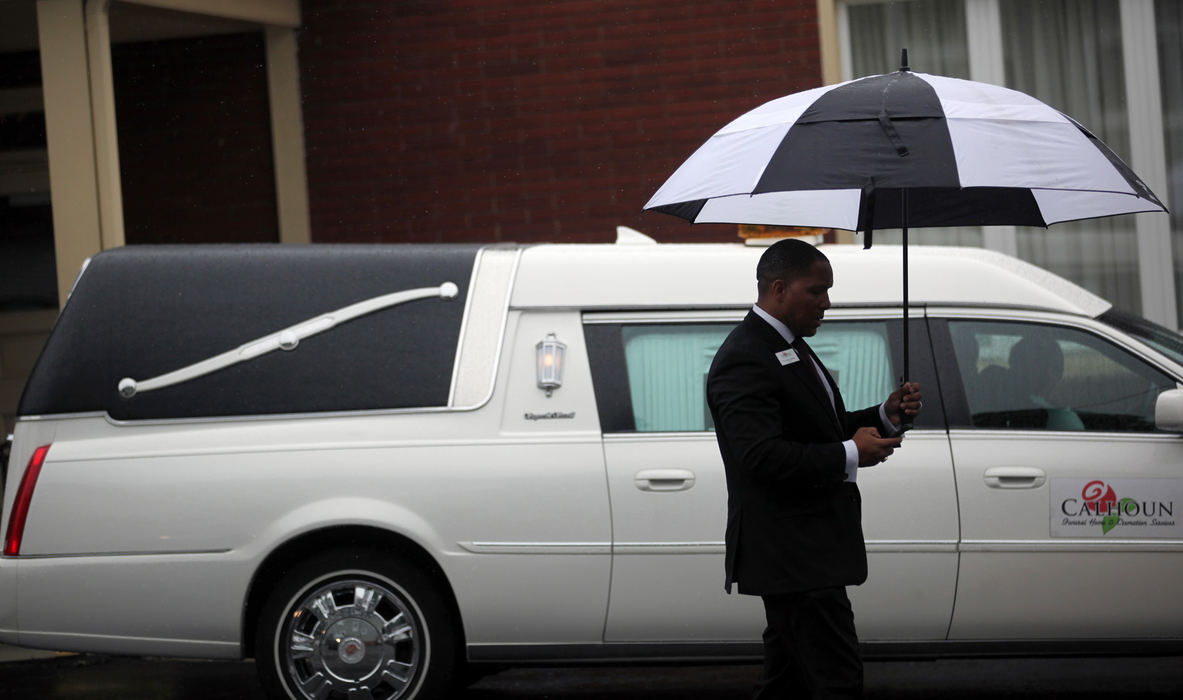 Award of Excellence, News Picture Story - Gus Chan / The Plain DealerThe hearse containing the body of Angela Deskins prepares to head for the cemetery.  Deskins' body was one of three found last weekend on a tip by Michael Madison, the accused murderer.   Deskins was the first of the women to be buried.  