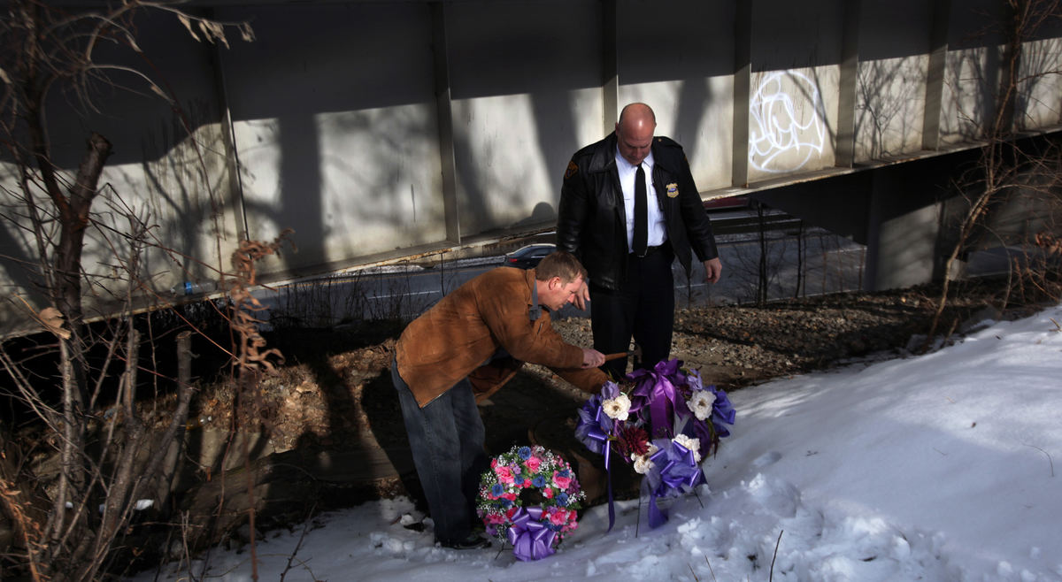 Award of Excellence, News Picture Story - Gus Chan / The Plain DealerCleveland police place two markers on the site where the body of Christina Adkins was found.  Adkins' body was stuffed in a manhole and her remains went undiscovered for 18 years until her killer, Elias Acevedo, confessed to the crime.