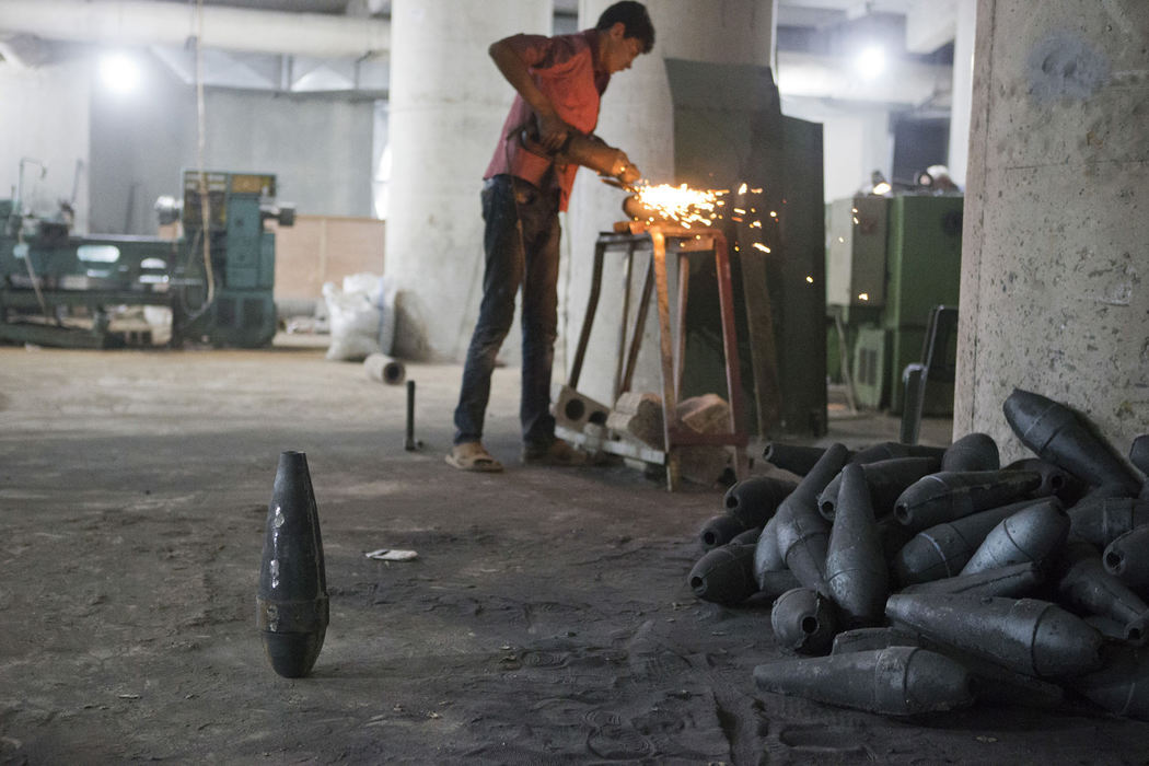 Award of Excellence, News Picture Story - Coty Giannelli / Kent State UniversityA young worker grinds off the sharp edges from a mortar shell that will be filled, assembled and shipped to the front lines from this location in northern Syria on June 22, 2013. Running out of weapons and with little help from the outside world the Free Syrian Army has set up it's own munitions factories. This young laborer works in an underground factory that produces munitions for one of the most powerful Free Syrian Army brigades in the area, The Ahrar Suriyah. This factory is so secret that most of the fighters have no clue about its existence.