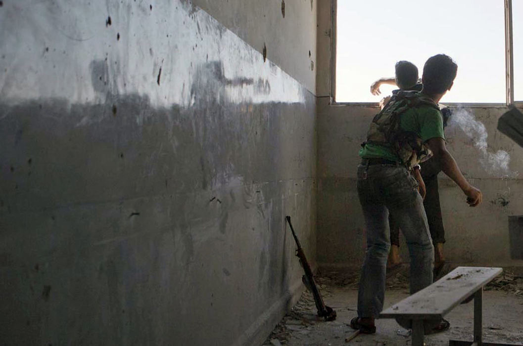 Award of Excellence, News Picture Story - Coty Giannelli / Kent State UniversityYoung Free Syrian Army fighters throw grenades into the neighboring building, where regime troops have taken control, in Aleppo on June 27, 2013. As the fighting in Aleppo intensifies, the front lines disappear and combatants are forced to fight building to building.untitled