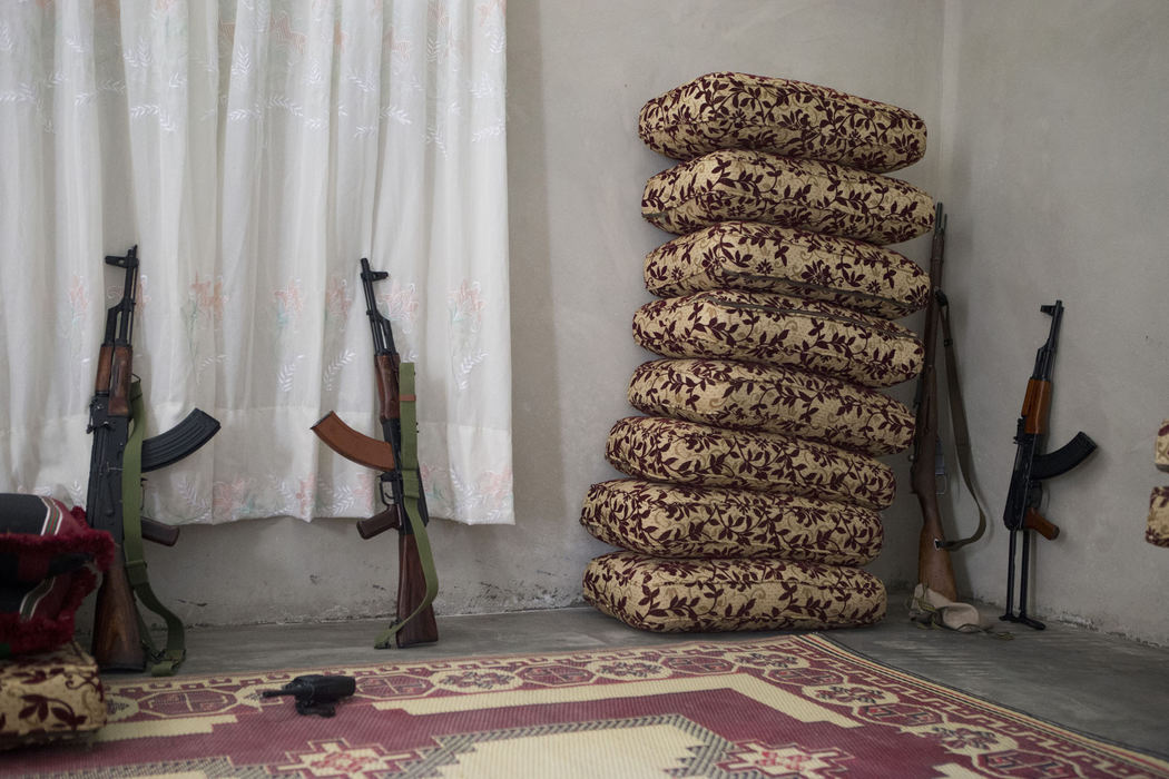 Award of Excellence, News Picture Story - Coty Giannelli / Kent State UniversityA group of rebel fighters rest their weapons against a wall as they take time to pray in a small house outside of Aleppo on June 21, 2013. Syria is a volatile country, so chaotic that those involved in the conflict, and some who are not, carry a weapon at all times