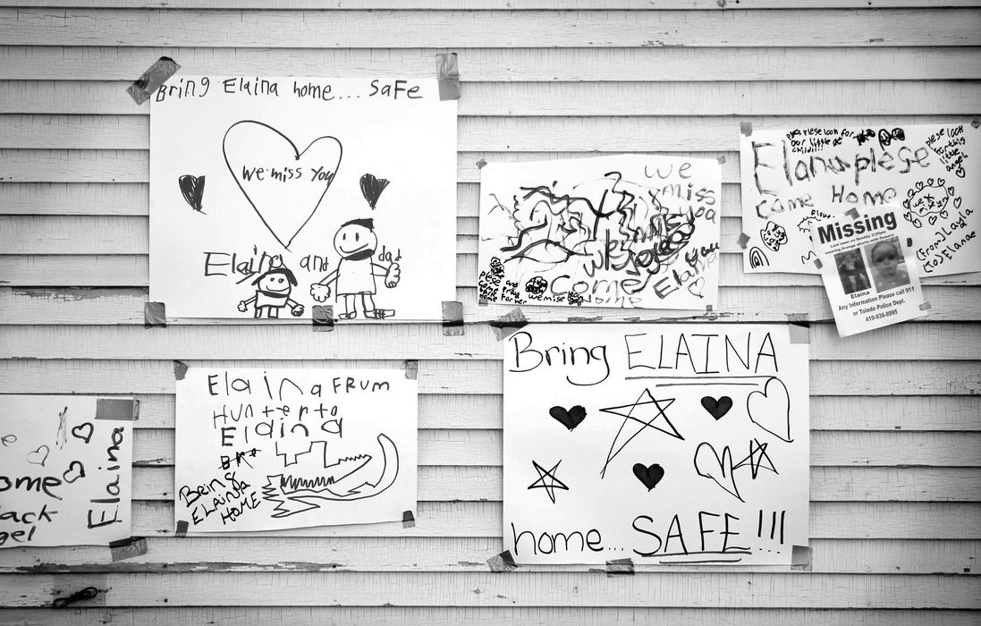 First Place, News Picture Story - Amy E. Voigt / The (Toledo) BladeHand-written signs hang on the side of a home near Federal and Leonard streets in honor of  missing toddler Elaina Steinfurth on June 5, 2013.