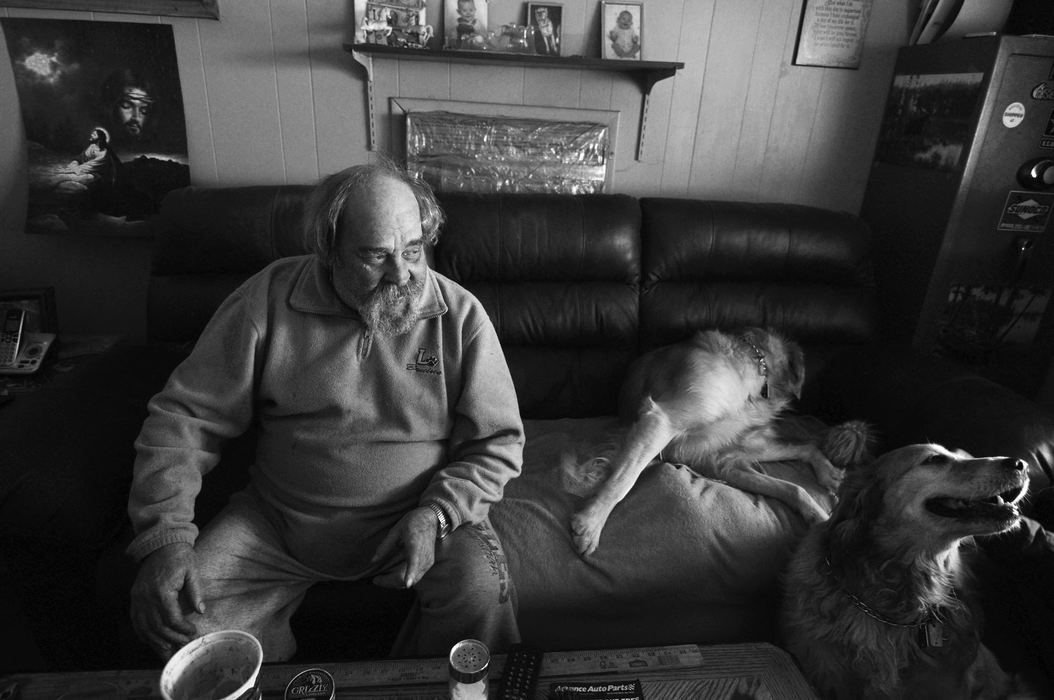 First Place, James R. Gordon Ohio Undertanding Award - Jacob Byk / Kent State UniversityRoy “Nutty” Pry sits with his two golden retrievers, Sassy and Rocco, in his home in January 2013. A Purple Heart veteran of the Vietnam War, Pry has lived in — and worked in the mine under — Nemacolin his entire life.  As of December 2013, Pry is seeking treatment for cancer contracted from Agent Orange at a VA Hospital in Pittsburgh, PA. 