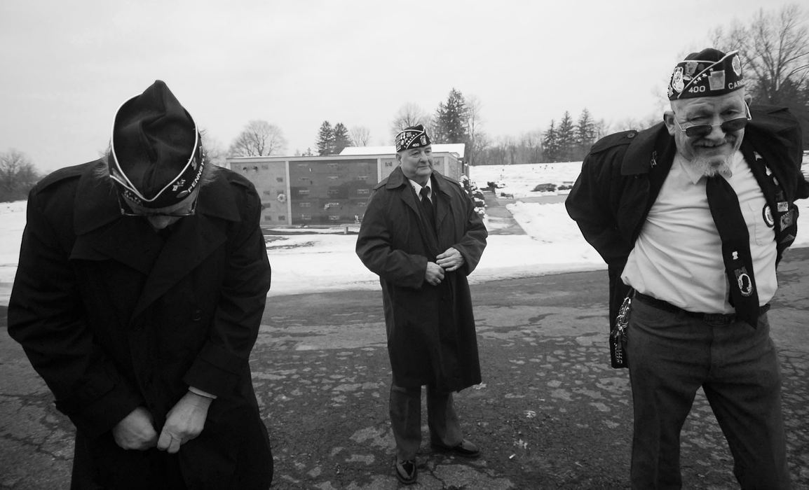 First Place, James R. Gordon Ohio Undertanding Award - Jacob Byk / Kent State UniversityBernie Ziglear fixes the zipper on his jacket, Richard MtJoy buttons up his jacket and Clarence "JoJo" McMannus tells a joke to lighten the mood while tucking in his shirt before participating in a funeral near Carmichaels in January 2013. The three veterans are part of the Carmichaels American Legion 400 and Honor Guard, and many members have direct ties to the coal industry.