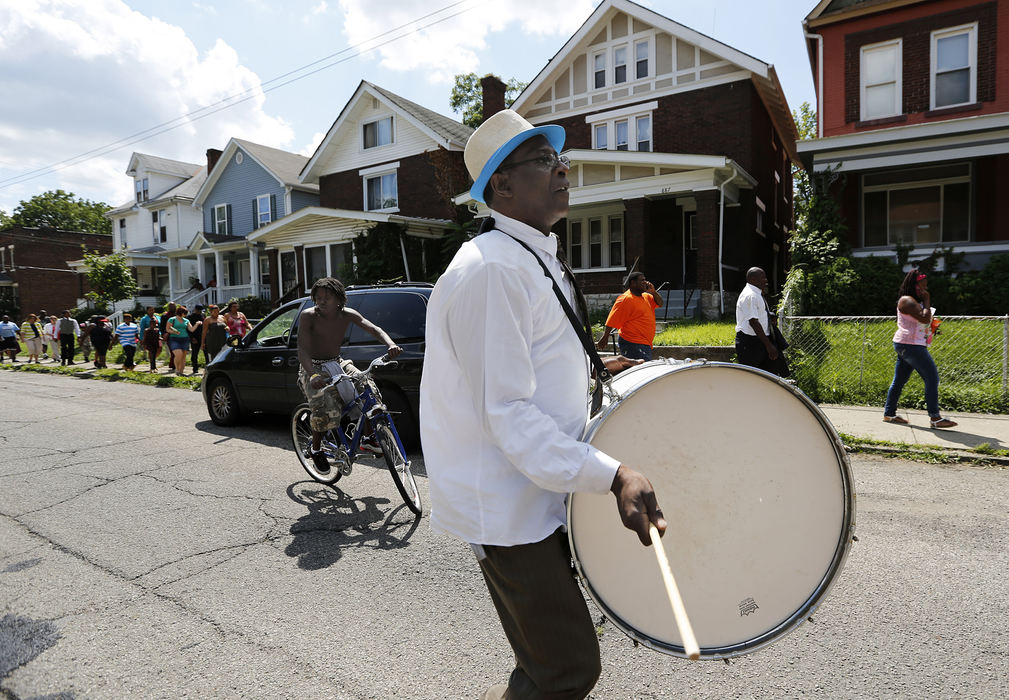 Second Place, James R. Gordon Ohio Undertanding Award - Eamon Queeney / The Columbus DispatchPastor Frank Towns beats on a large drum as he helps lead the 46th South Side March, Sunday afternoon, August 4, 2013. On the first Sunday of every month the community around the Family Missionary Baptist Church on the South Side stages a march against violence. An 42-block area on the South Side plagued with shootings and nicknamed Soufganistan by the youth there went almost 2 years with no deaths until this summer. 